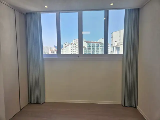 안방 창 양쪽에 암막 겉커튼을 열어 둔 모습